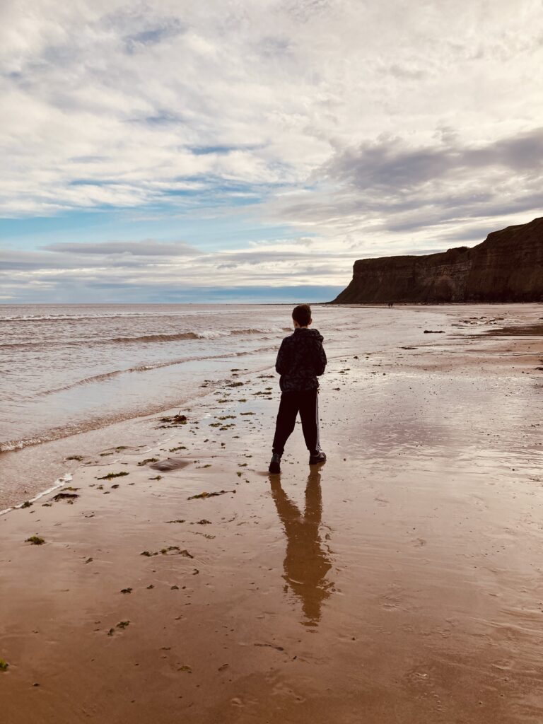 Boy on the beach in Saltburn-by-the-Sea, North Yorkshire