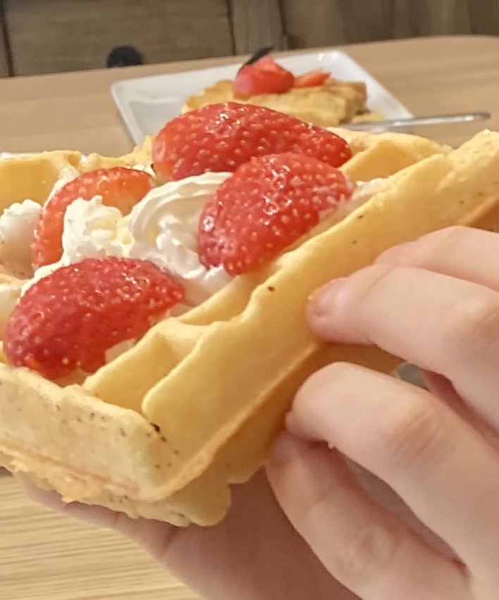 Strawberry topped waffle at a waffle making workshop in Bruges