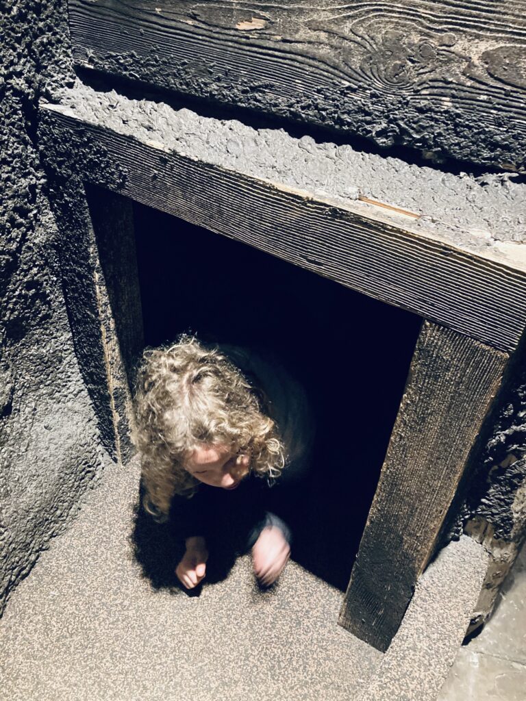 Crawling through a trench on a visit to the Castle Museum, York
